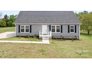 Charming single-story home with gray siding, a gray roof, and a well-manicured lawn at 123 Pumice Dr, Statesville, NC 28625