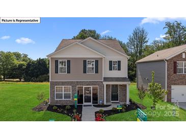 Charming two-story home with a landscaped front yard, brick accents, and dark shutters at 14018 Wilson Mac Ln, Charlotte, NC 28278