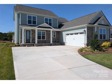 Charming two-story home featuring stone accents, a covered porch, and a spacious two-car garage at 2069 Fordhill St, Rock Hill, SC 29732