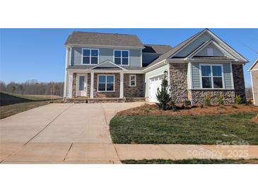 Charming two-story home with stone accents, attached garage, and well-manicured lawn at 2069 Fordhill St, Rock Hill, SC 29732