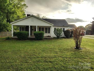 Charming one-story home with a covered front porch, manicured lawn, and mature landscaping at 2508 S Main St # 68, Concord, NC 28027
