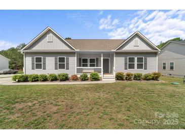 Charming single-story home with manicured lawn and covered front porch seating for relaxed, outdoor enjoyment at 367 Neely Store Rd, Rock Hill, SC 29730