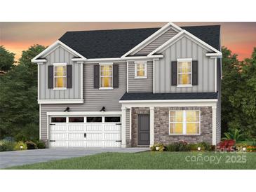 Charming two-story home with gray siding, stone accents, and a two-car garage at 3901 Pee Dee St # 31, Monroe, NC 28110