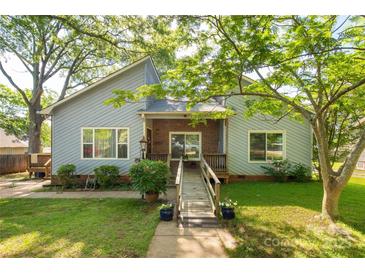 Charming single-story home featuring light blue siding, brick accents, mature landscaping, and a welcoming ramp entrance at 441 Kimbrook Ct, Rock Hill, SC 29730