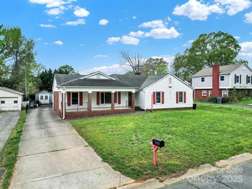Charming single-story home with a well-manicured lawn and inviting front porch at 7410 Middlebury Pl, Charlotte, NC 28212
