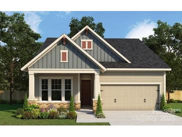 Charming craftsman-style home with a two-car garage, lovely landscaping, and eye-catching architectural details at 1107 Meander Ln, Waxhaw, NC 28173