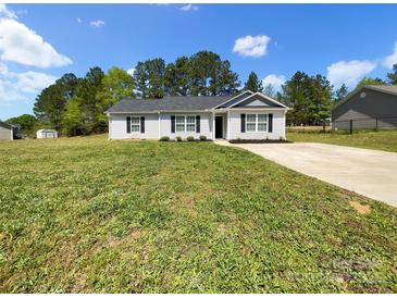 Charming single story home featuring a well-manicured lawn and a concrete driveway at 1399 Foxbrook Cir, Lancaster, SC 29720