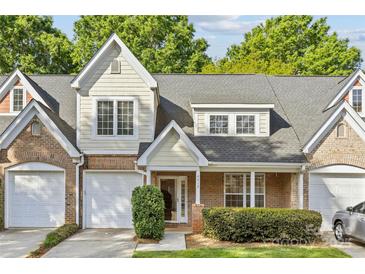 Charming townhouse with a brick and light yellow siding, attached garages, and well-maintained landscaping at 4418 Coventry Row Ct, Charlotte, NC 28270
