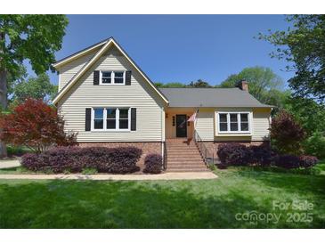Charming two-story home with landscaped front yard and traditional architectural details at 6008 Corkstone Dr, Mint Hill, NC 28227