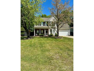 Traditional two-story home with inviting porch and a well-maintained lawn at 9003 Brad Ct, Matthews, NC 28104