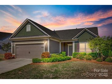 Charming single-Gathering home featuring a two-car garage and meticulously landscaped front yard at 953 Kirby Dr, Fort Mill, SC 29715