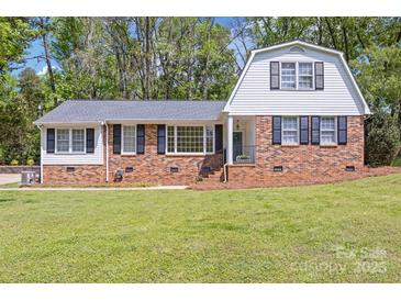 Charming brick home with a gambrel roof, well-manicured lawn, and inviting curb appeal at 101 Grier St, York, SC 29745