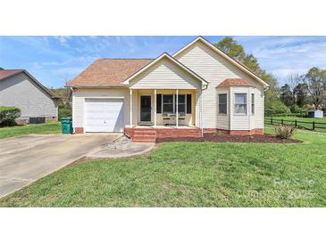 Charming one-story home features a front porch, green lawn, and attached one-car garage at 2703 Plantation Way, Albemarle, NC 28001