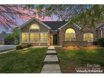 Charming home showcasing a blend of siding and stone finishes, enhanced by a beautifully landscaped front yard at 6311 Ridge Path Ln, Charlotte, NC 28269