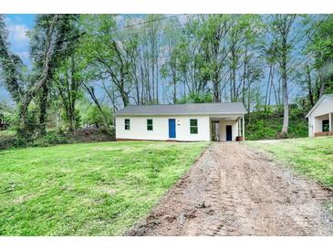 Quaint single-story home featuring fresh exterior paint, a bright blue door, and spacious front yard at 805 32Nd Street Ne Dr, Conover, NC 28613