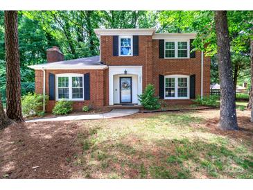 Charming two-story brick home with black shutters and well-manicured landscaping at 8807 Tree Haven Dr, Charlotte, NC 28270