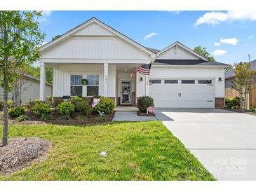 Charming home with a well-maintained lawn and a welcoming front porch at 9077 Myrna Dr, Gastonia, NC 28056