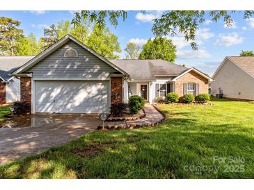 Charming single-story home features a brick and siding exterior, attached garage, and well-manicured front lawn at 909 Jordans Pond Ln, Charlotte, NC 28214