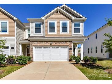 Charming two-story home with a stone accent garage, neutral siding, and well-manicured landscaping at 9134 Northfield Crossing Dr, Charlotte, NC 28269