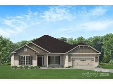 Charming single-story home featuring a two-car garage, well-manicured lawn, and traditional architectural details at 1035 Gardenia Dr # 51, Mt Ulla, NC 28125