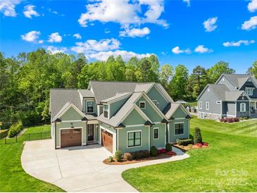 Beautifully landscaped home featuring a two-car garage and welcoming front yard at 108 Castleview Ln, Mooresville, NC 28115