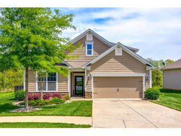 Charming two-story home with a well-manicured lawn, featuring a two-car garage and a lovely front yard at 124 Rosebay Dr, Mooresville, NC 28117
