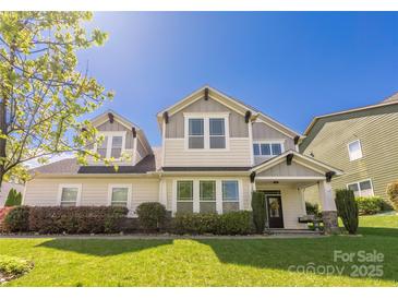 Charming home with a well-manicured lawn and inviting front porch at 12942 Blakemore Ave, Huntersville, NC 28078