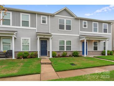 Gray siding townhome with well-maintained lawn and landscaping at 221 Century Dr, Salisbury, NC 28147