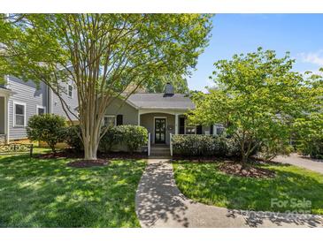 Charming bungalow with lush landscaping, inviting front porch, and a well-maintained walkway leading to the entrance at 3019 Sunset Dr, Charlotte, NC 28209