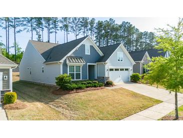Charming single-Gathering home featuring a two-car garage, manicured lawn, and architectural shingle roof at 529 Cellini Pl # 243, Mount Holly, NC 28120