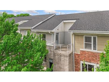 Exterior view of the home with neutral siding, brick accents, and a private balcony at 534 Donatello Ave, Charlotte, NC 28205