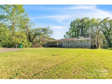 Charming single-Gathering home with a large front yard and inviting porch, perfect for relaxing outdoors at 5944 Freedom Dr, Charlotte, NC 28214