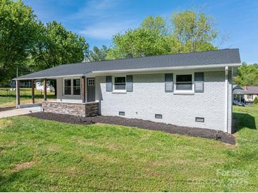 Charming one-story home with fresh, neutral paint, inviting curb appeal and a neatly maintained lawn at 692 S Pink St, Cherryville, NC 28021