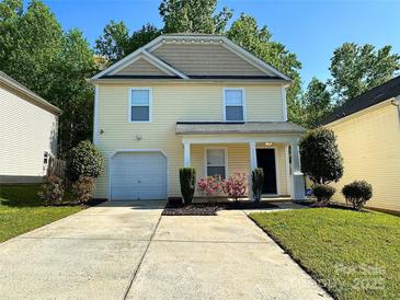 Charming two-story home with a well-manicured lawn and an attached garage at 8829 Michaw Ct, Charlotte, NC 28269