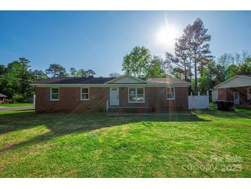 Charming single-story brick home with well-maintained lawn and mature trees at 1005 Clarkson St, Rock Hill, SC 29730