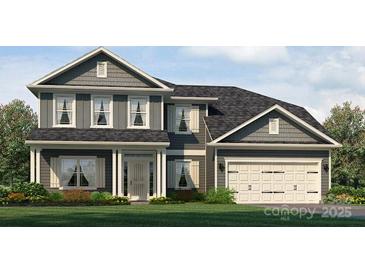 Charming two-story home featuring a manicured lawn and a two-car garage at 1465 Mocksville Hwy # 20, Statesville, NC 28625