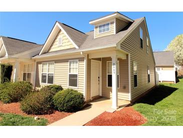 Charming townhouse featuring a tidy front lawn, tan siding, and a welcoming front entrance with address number at 2043 Shady Pond Dr, Clover, SC 29710