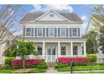 Stately home with inviting porch, detailed columns, and well-manicured landscaping at 2311 Lochview St, Pineville, NC 28134