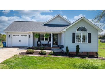 Charming single-story home features a well-manicured lawn and a welcoming front porch with decorative plants at 4808 Thoreau Dr, Conover, NC 28613