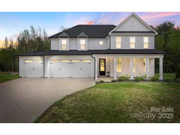 Stunning two-story home with three-car garage, manicured lawn, and inviting front porch at 8756 Sherrills Ford Rd, Sherrills Ford, NC 28673