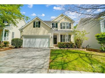 Charming two-story home featuring a two-car garage and manicured lawn at 10056 Paisley Dr, Charlotte, NC 28269