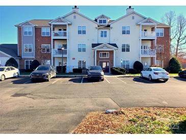 Well-maintained condo building featuring balconies and ample parking at 10526 Hill Point Ct, Charlotte, NC 28262