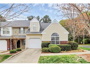 Charming townhome featuring a one-car garage, manicured landscaping, and a welcoming facade at 11539 Delores Ferguson Ln, Charlotte, NC 28277