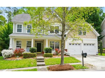 Charming two-story home with a well-manicured front yard, complemented by an attached two-car garage at 12531 Morning Creek Ln, Charlotte, NC 28214