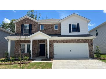Charming two-story home with brick accents, a two-car garage, and a well-manicured lawn at 138 Shepherds Landing Dr, Mooresville, NC 28115