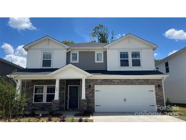 Charming two-story home featuring a stone facade, a two-car garage, and a welcoming front porch at 140 Shepherds Landing Dr, Mooresville, NC 28115