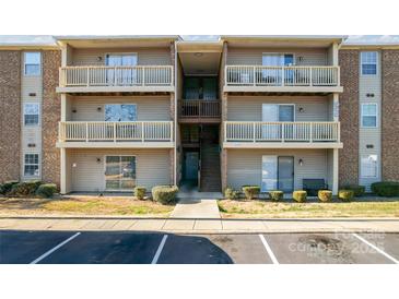 Three-story condo building featuring multiple balconies and updated facade at 1620#F Arlyn Cir, Charlotte, NC 28213