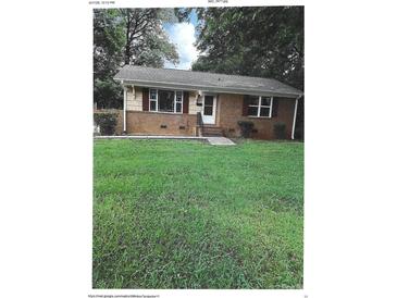 Charming single-story home with brick and siding exterior, and a large front yard at 2831 Denview Ln, Charlotte, NC 28208