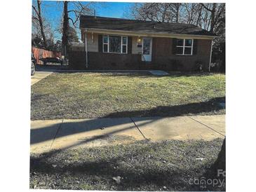 Charming brick home featuring a well-kept lawn and a cozy, inviting exterior at 2831 Denview Ln, Charlotte, NC 28208