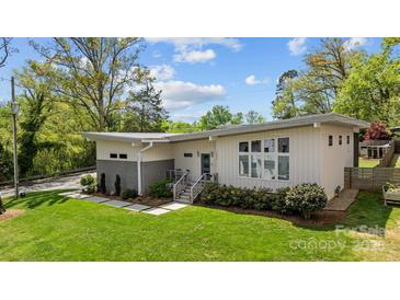 Modern home showcasing a manicured lawn, stylish landscaping, and contemporary architectural details at 3036 Palm Ave, Charlotte, NC 28205